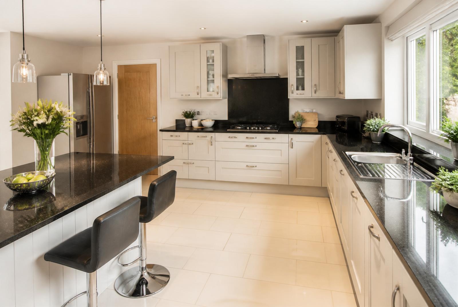Spotlessly deep-cleaned domestic kitchen with gleaming worktops, streak-free hob and polished stainless-steel sink